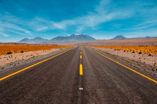 Open road with yellow lane markings toward the mountains